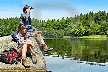 Caucasian teenage hikers birdwatching at lake