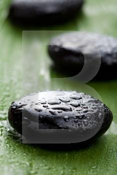 black spa stones over leaf