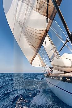 Sailing yacht on the race in blue sea