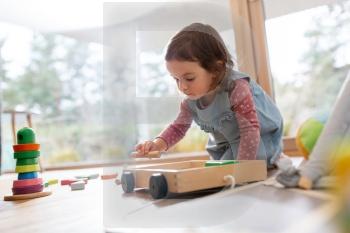childhood, hygge and people concept - little baby girl playing with toy blocks at home. happy baby girl playing with toy blocks at home