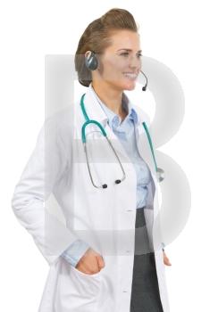 Smiling doctor woman in headset looking on copy space