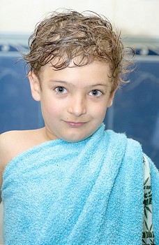 boy after bath in blue towel