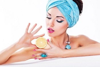 Beauty Woman Holding a Fresh Lemon in Hands - Clean Healthy Skin