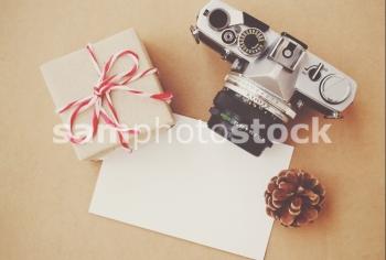 Handmade gift box and film camera on blank card with retro filter effect