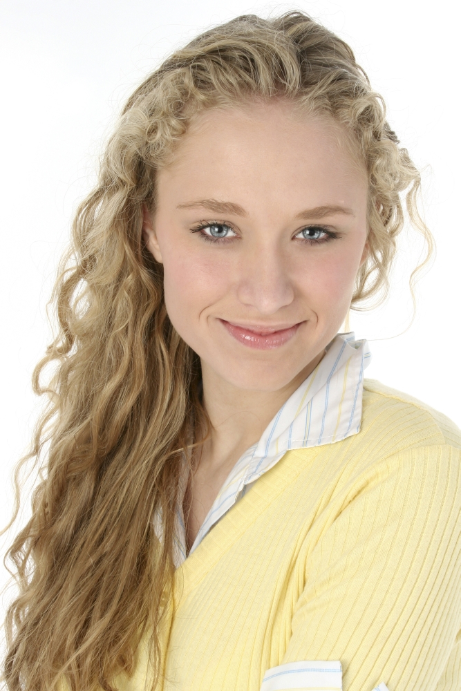 Beautiful young American woman with long curly blonde hair and blue eyes. Shot over white. Natural beauty... very light make-up.