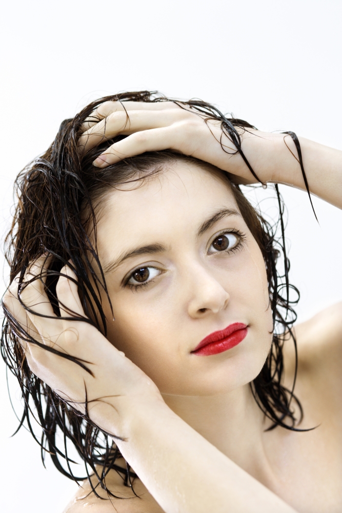 Portrait of attractive Caucasian young woman redhead with wet hair.