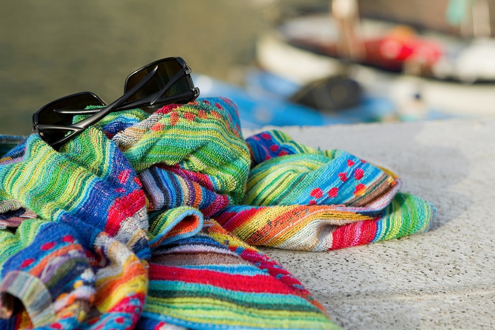 Close-up of towels with a sunglasses, Cinque Terre National Park, Vernazza, La Spezia, Liguria, Italy