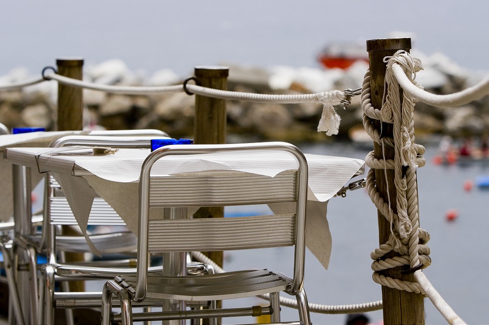 Chairs and table at a sidewalk cafe, Italian Riviera, Cinque Terre National Park, Il Porticciolo, Vernazza, La Spezia, Liguria, Italy