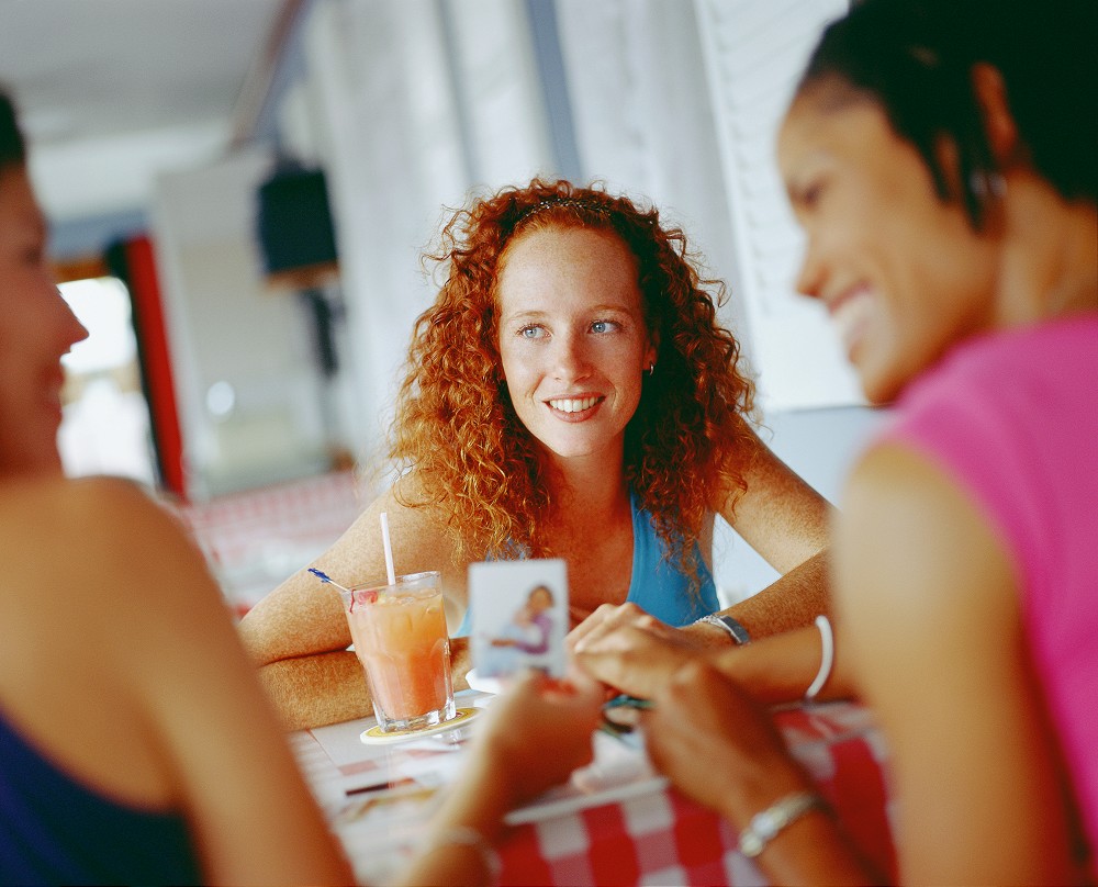 Three young women sitting around a table, Bermuda
