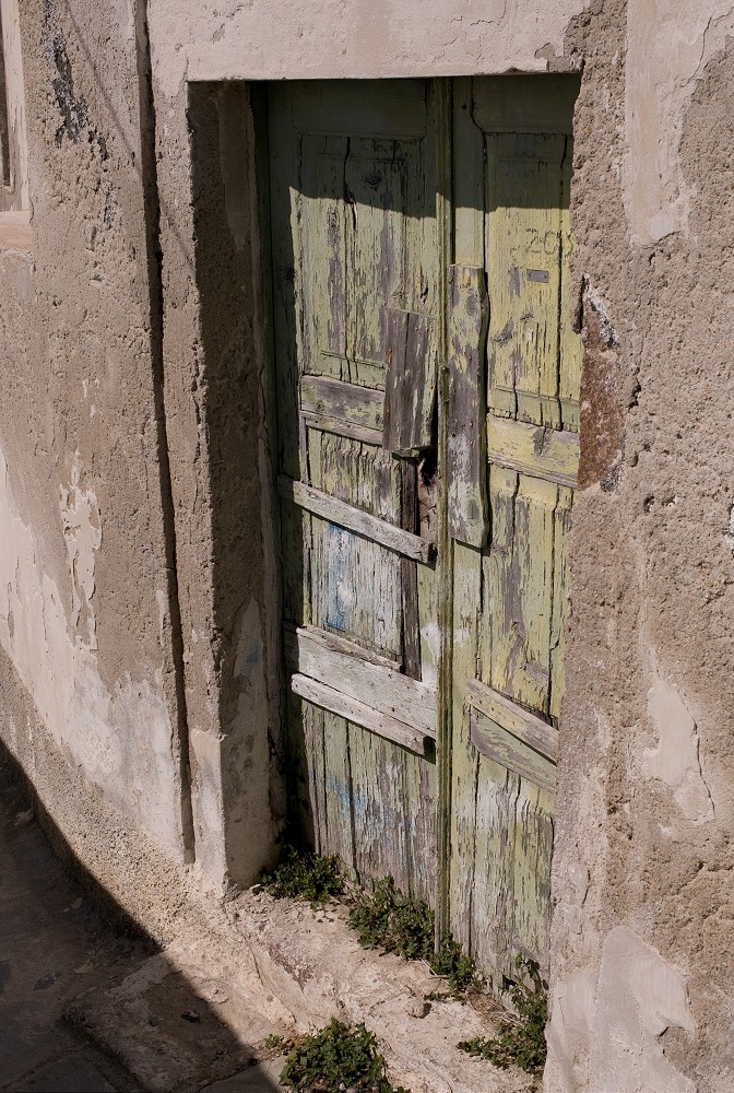 Weathered wooden doors in Santorini Greece