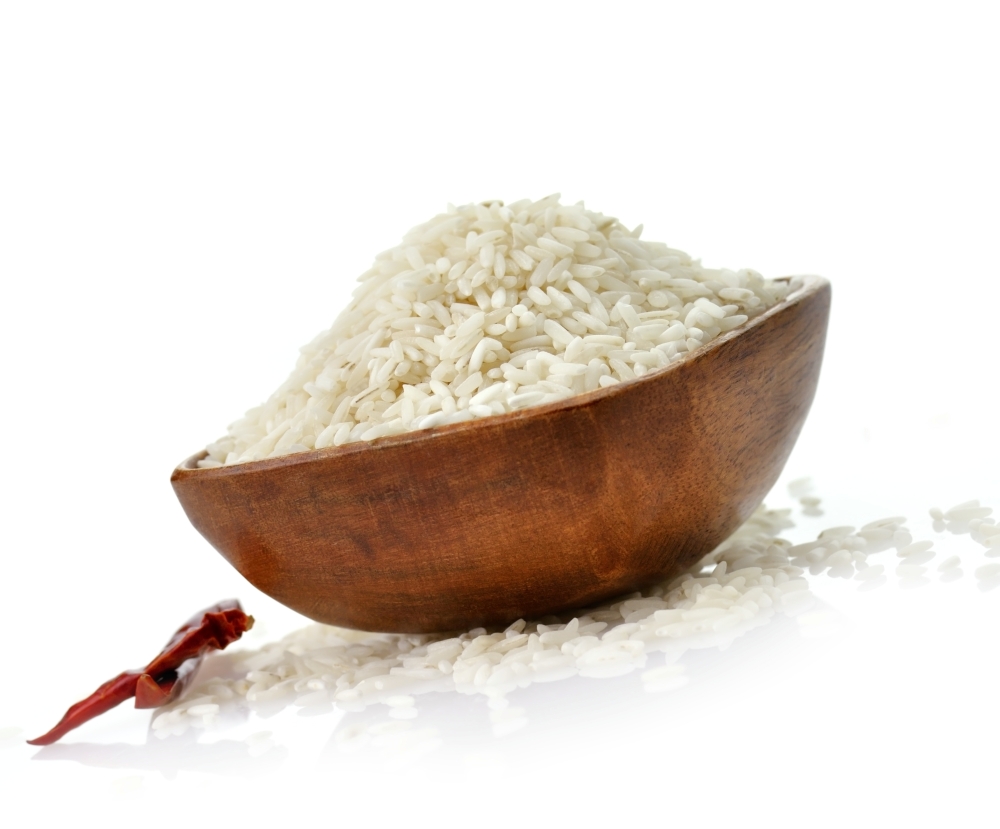 raw white rice , close up in a wooden bowl