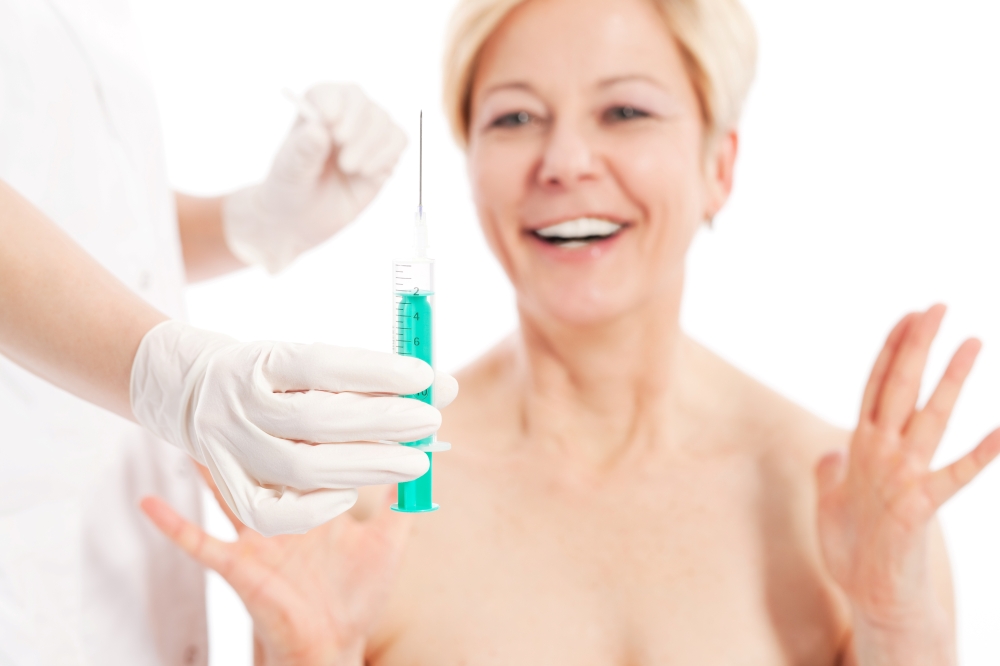 Botox - Age and beauty; doctor is waiting with needle