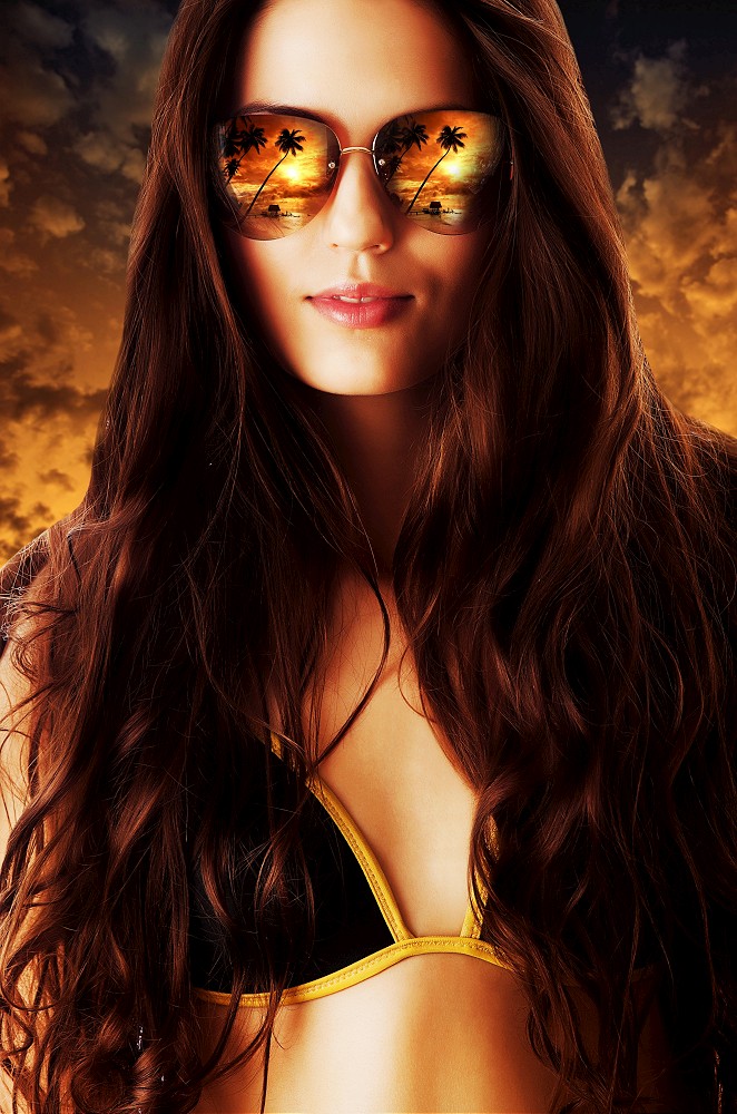 close-up portrait of woman in sunglasses on the beach