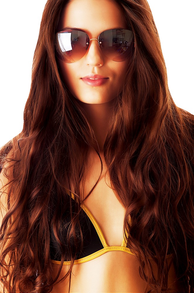 close-up portrait of woman in sunglasses on white background