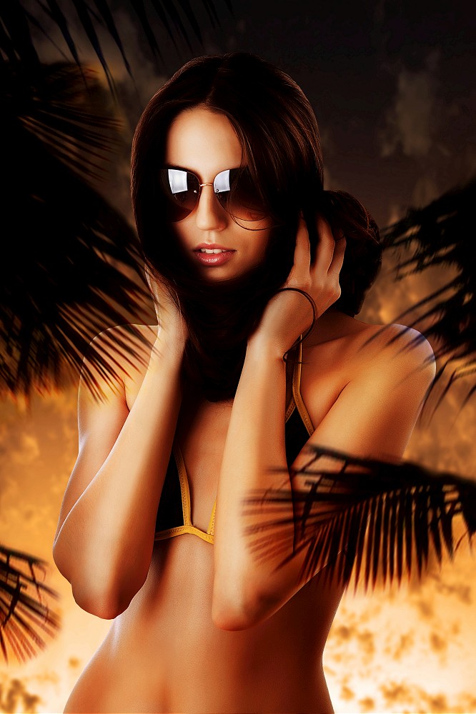woman in sunglasses at sunset and hair around neck
