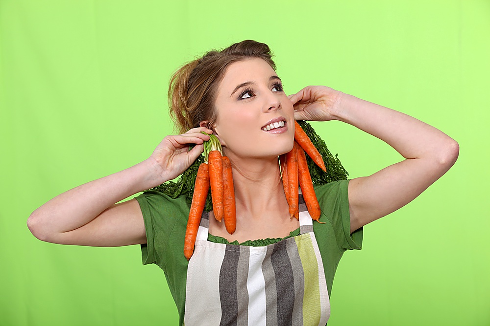 Girl with carrots as earrings