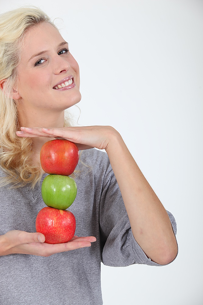 woman holding three apples
