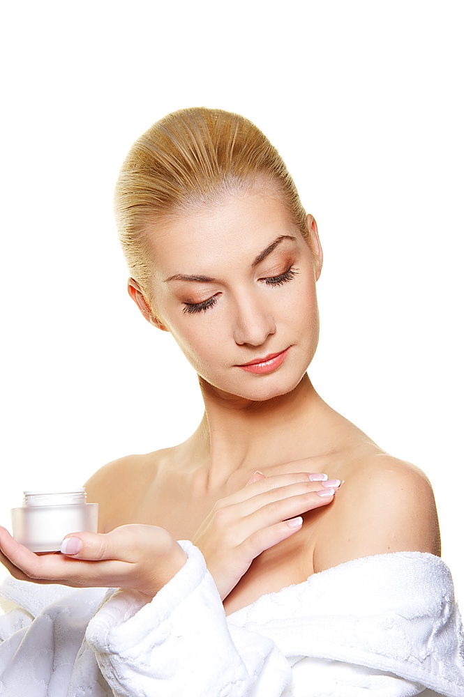 Woman applying moisturizer cream on her body