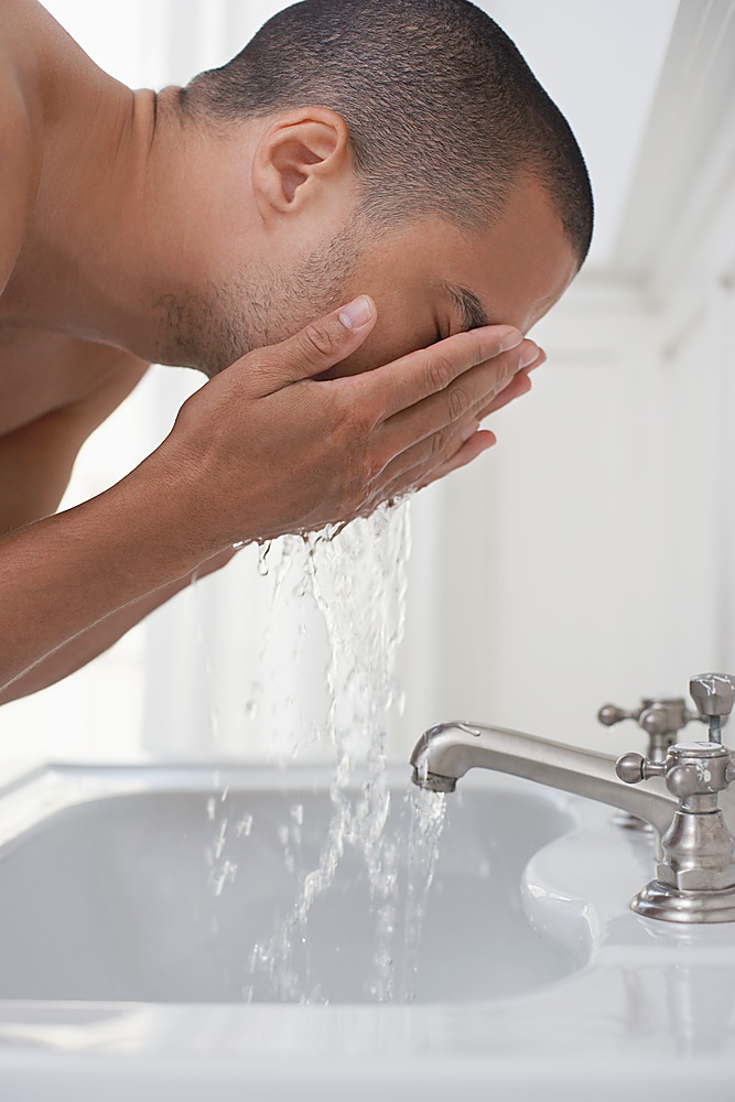 Man Rinsing His Face