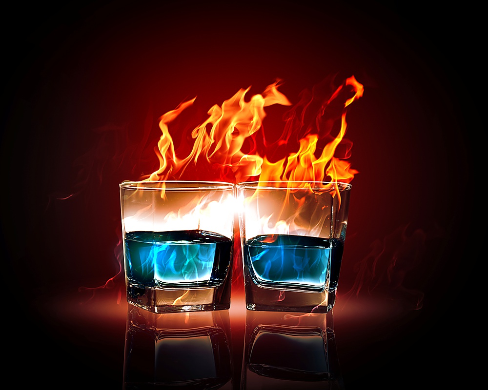 Image of two glasses of burning emerald absinthe