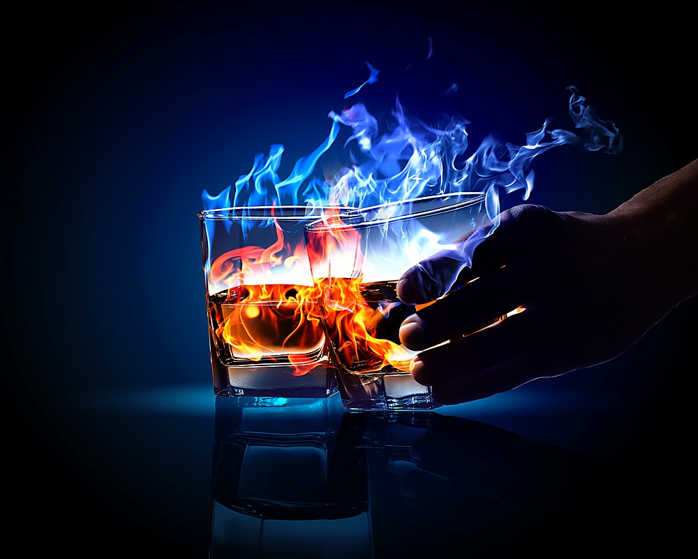 Image of two glasses of burning absinthe