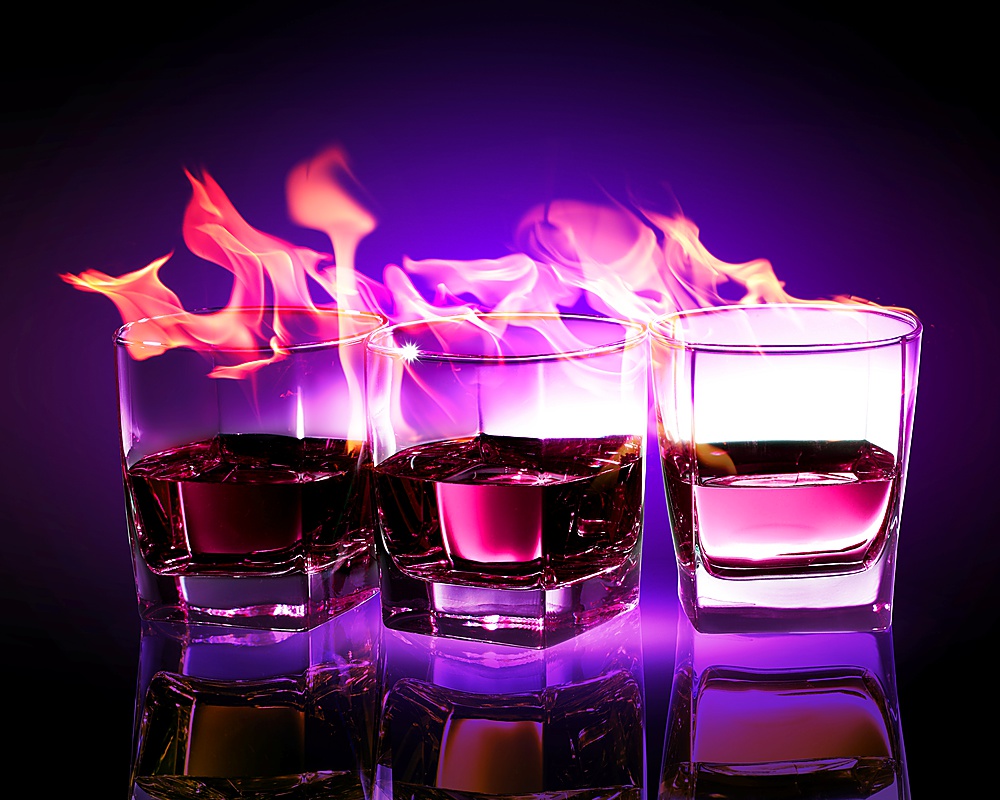 Image of three glasses of burning puple absinthe