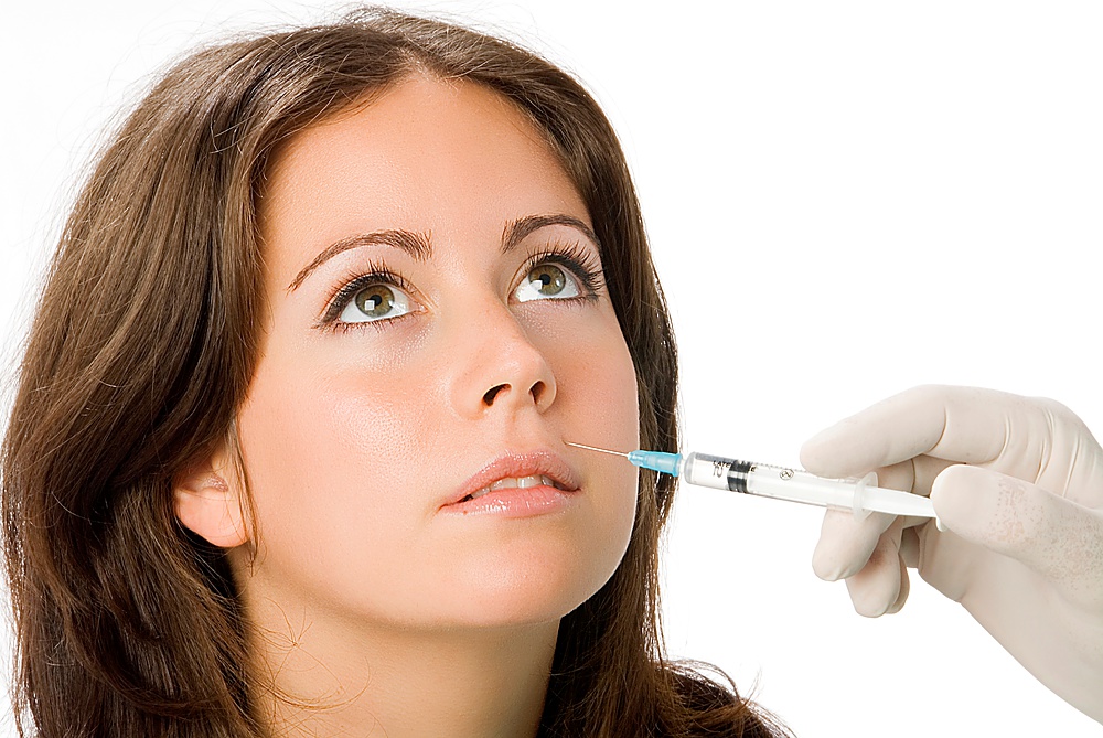 Portrait of fresh and beautiful woman getting botox injection