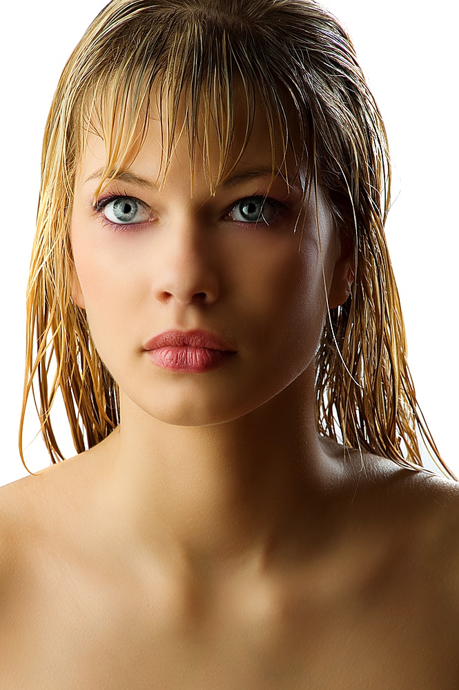 attractive and beautiful blond girl with long wet hair looking away