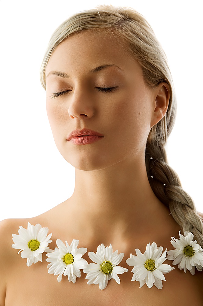 closed eyes portrait of a beautiful woman with twist braid and a flowers necklace