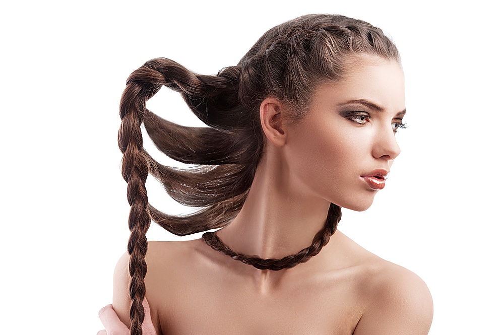 beauty profile shot of a beautiful brunette with long braided hair on white
