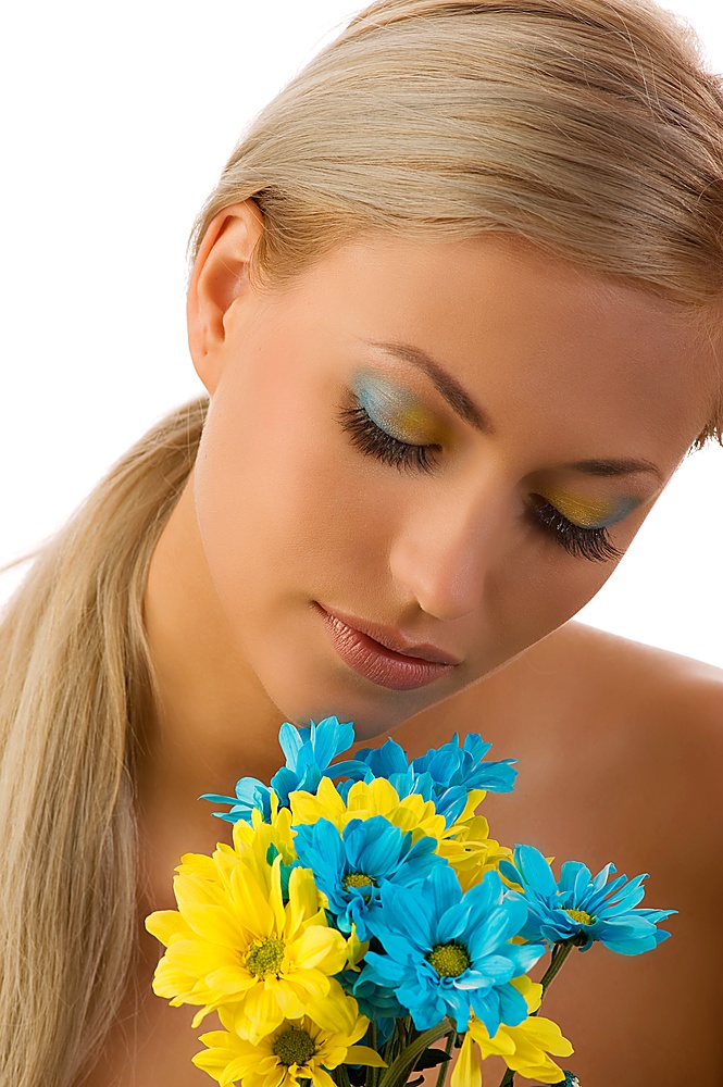 cute girl with colored flowers and closed eyes with yellow and blue make up
