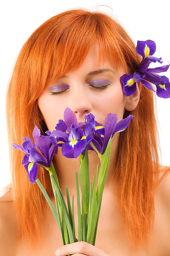 Close-up of beautiful young model with closed eyes and purple flower