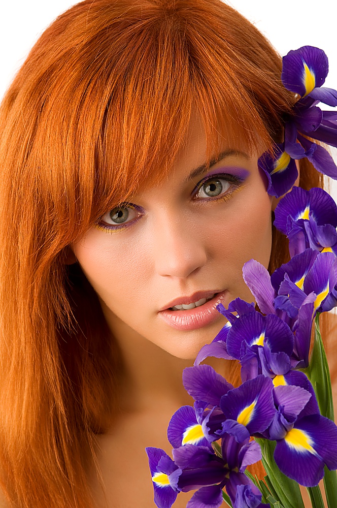 pretty close up of a young and cute red haired girl with purple flowers