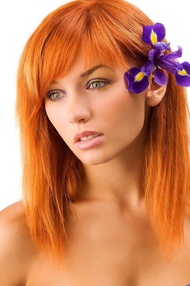 portrait of  beautiful young model with flower and long red hair