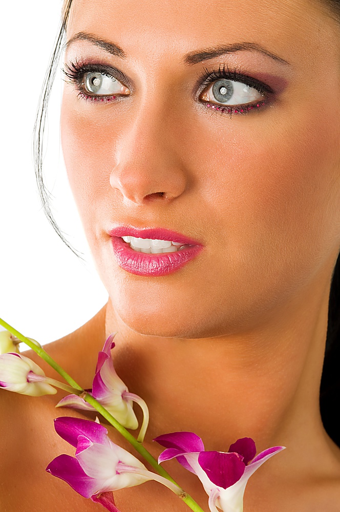 beauty portrait of pretty girl with blue eyes and pink orchid