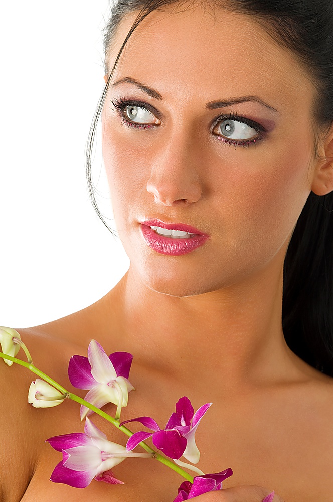 beauty portrait of young brunette with blue eyes and pink orchid