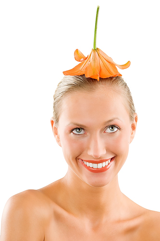 nice girl smiling with an orange flower on her head used like a hat