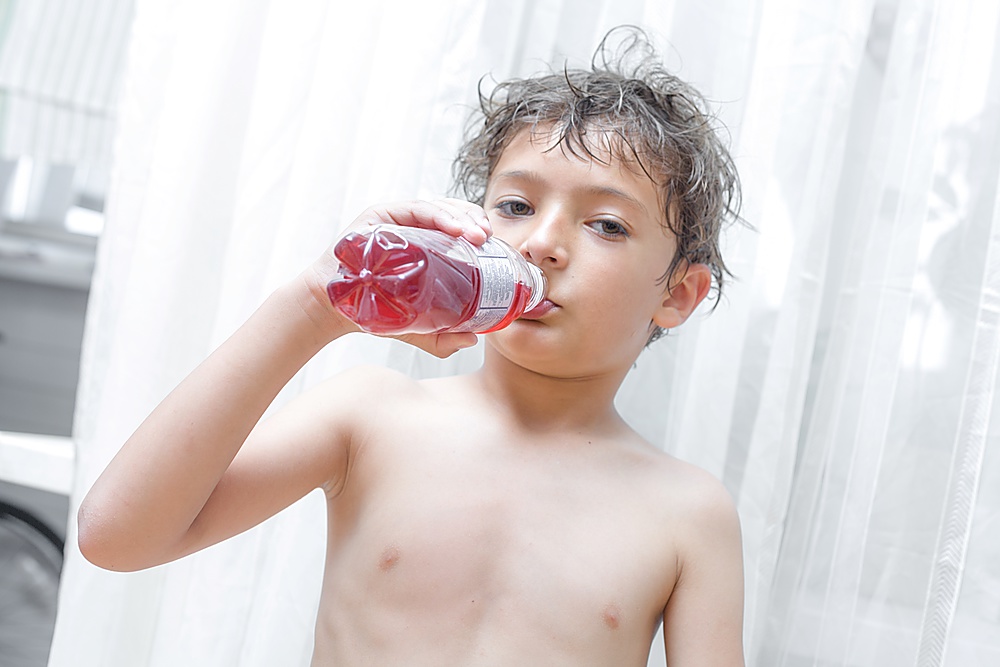 kid holding plastic bottle