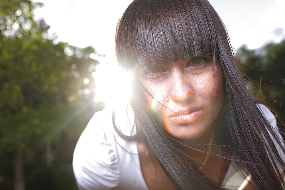 young adorable woman closeup backlit