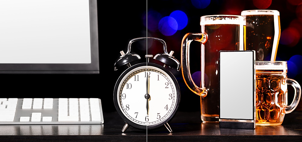 beer party after working day. Glasses of beer, office computer with clock and mobile phone
