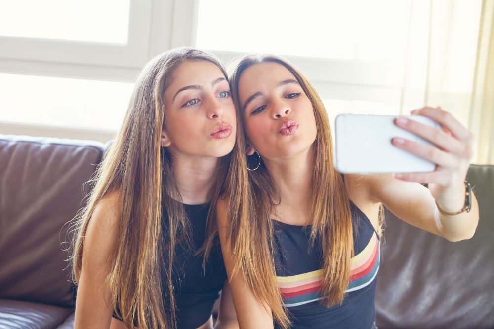 Teenager girls best friends makeup selfie camera. Teenager girls best friends makeup selfie camera in smartphone make-up