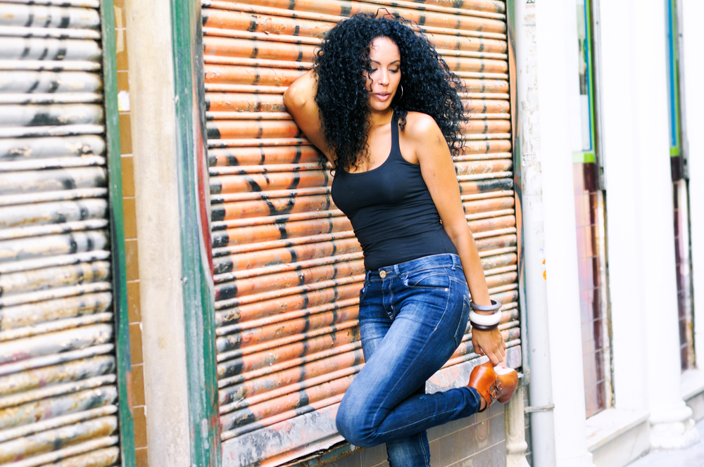 Portrait of a young black woman, model of fashion wearing high heels, in urban background
