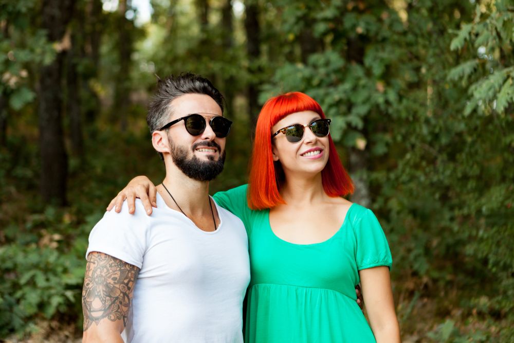 Young couple of lovers with sunglasses in the park