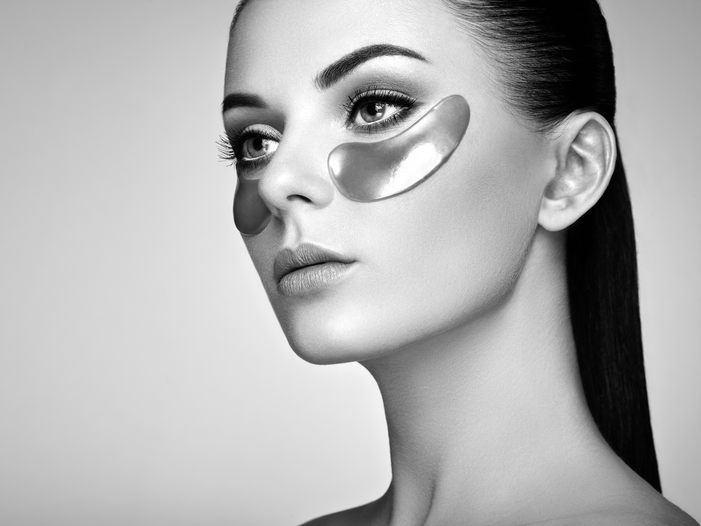 Portrait of Beauty Woman with Eye Patches. Woman Beauty Face with Mask under Eyes. Beautiful Female with natural Makeup and Cosmetics Collagen Patches on Fresh Facial Skin