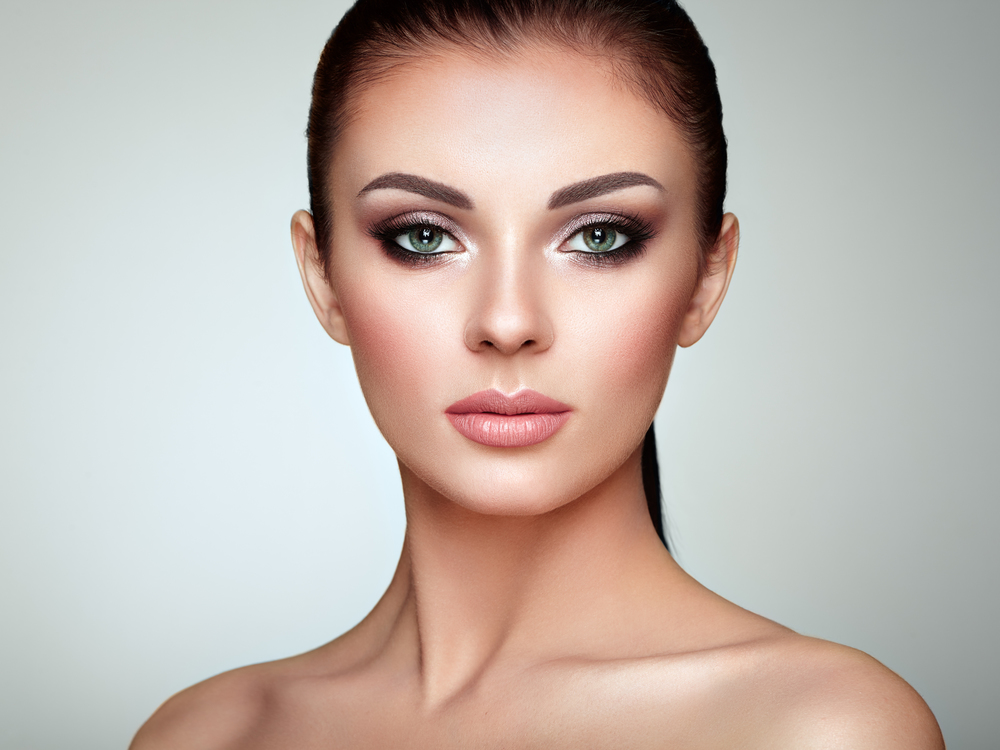 Beautiful woman face with perfect makeup. Beautiful Young Woman with Clean Fresh Skin. Perfect Makeup. Beauty Fashion. Eyelashes. Cosmetic Eyeshadow. Highlighting. Cosmetology, Beauty and Spa