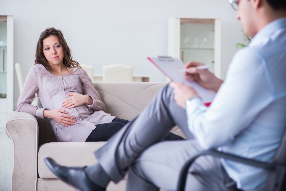 Pregnant woman visiting psychologist doctor. The pregnant woman visiting psychologist doctor