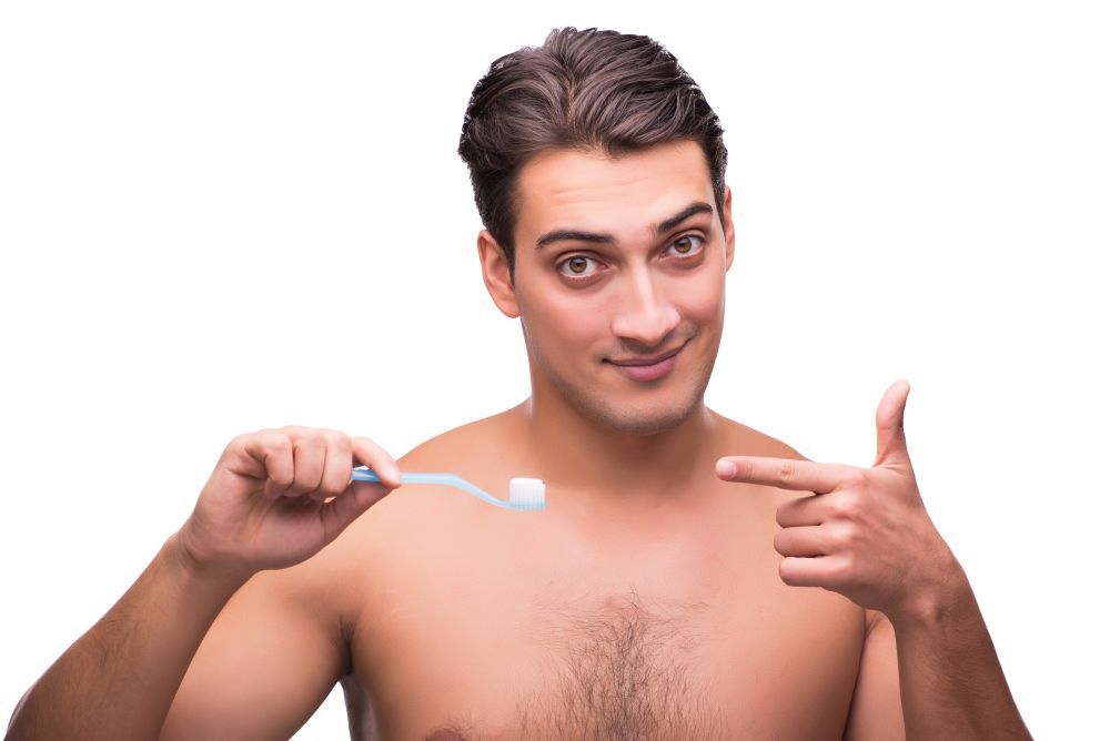 Man brushing his teeth isolated on white
