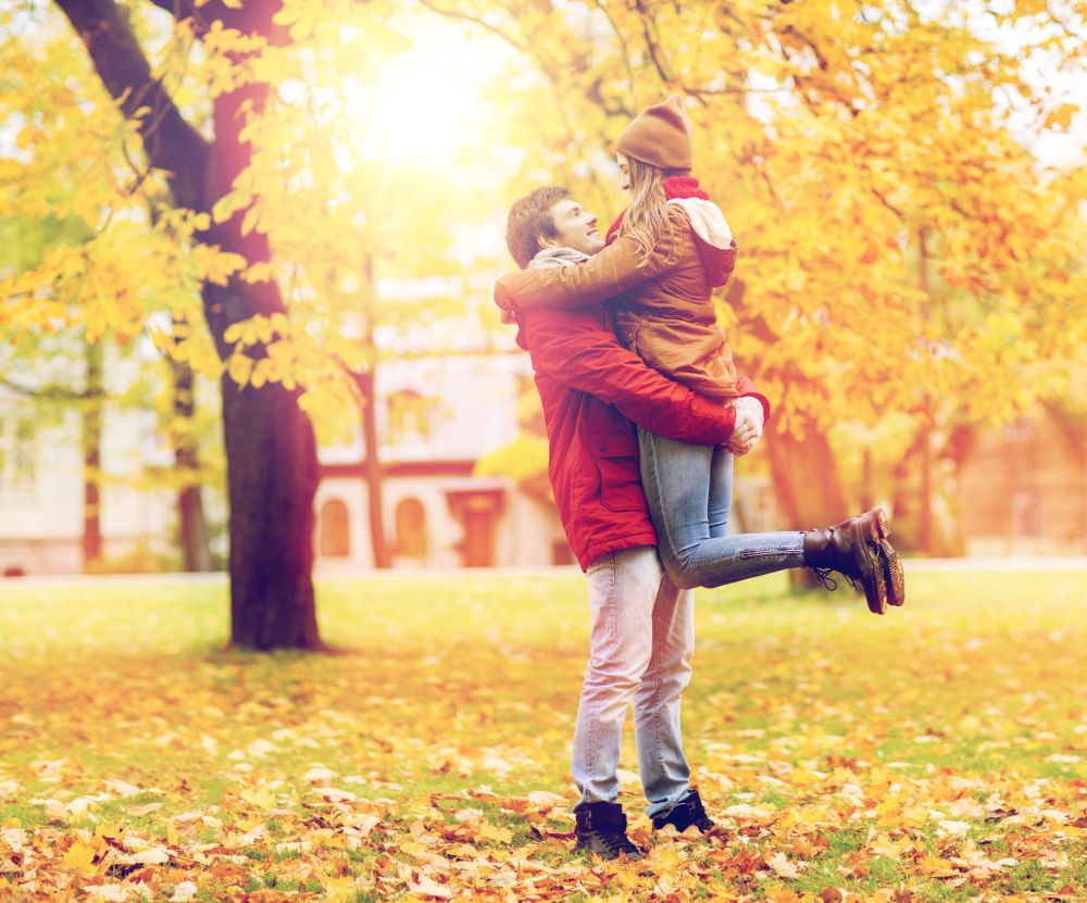 love, relationships, season and people concept - happy young couple meeting in autumn park. happy young couple meeting in autumn park