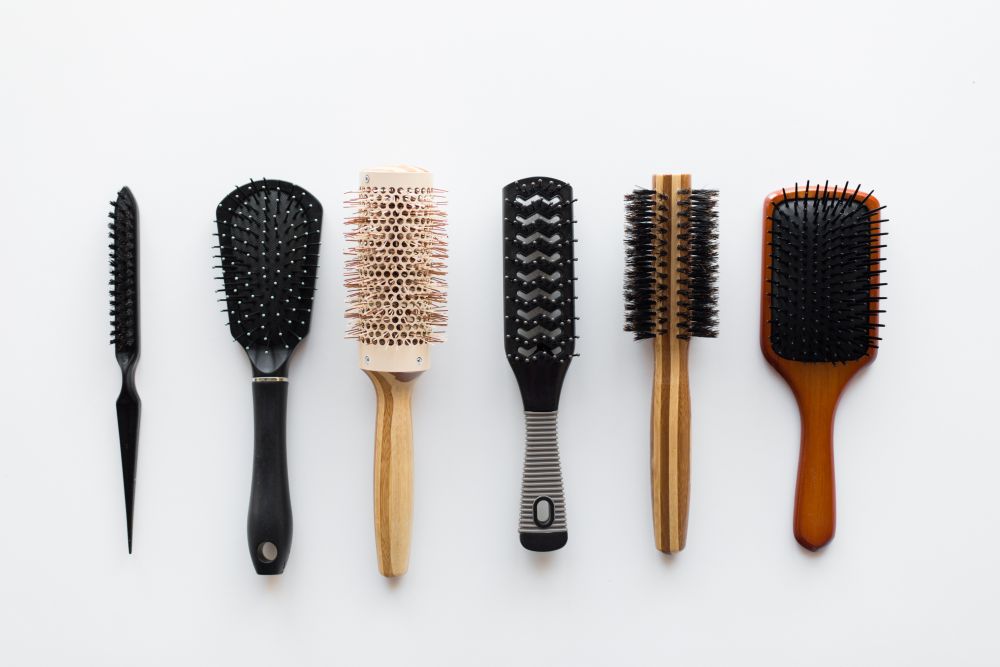 hair tools, beauty and hairdressing concept - different brushes or combs on white background. different hair brushes or combs from top