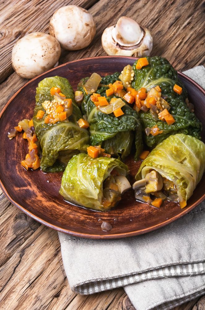 Vegetarian cabbage rolls on plate. Ukrainian vegetable dietary cabbage rolls in leaf of savoy cabbage
